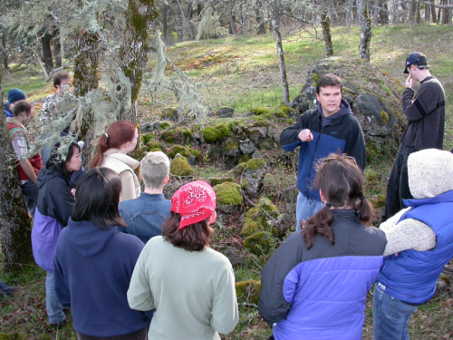 Darcy Matthews leading a UVic field trip to burial features in Metchosin.  Photo:qmackie